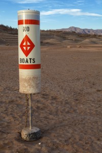 Buoy in dried up lake.