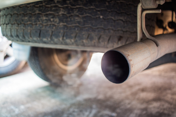 Car giving off exhaust closeup