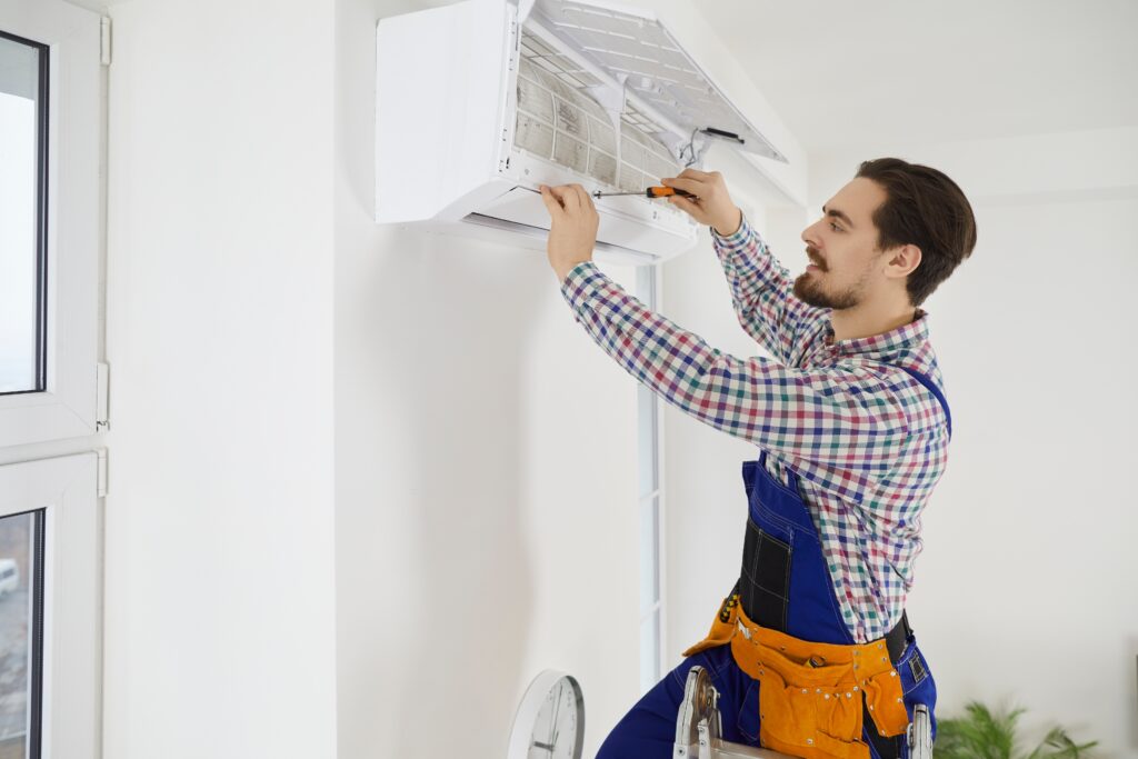 technician performing ac maintenance that keeps your system ready for every heatwave