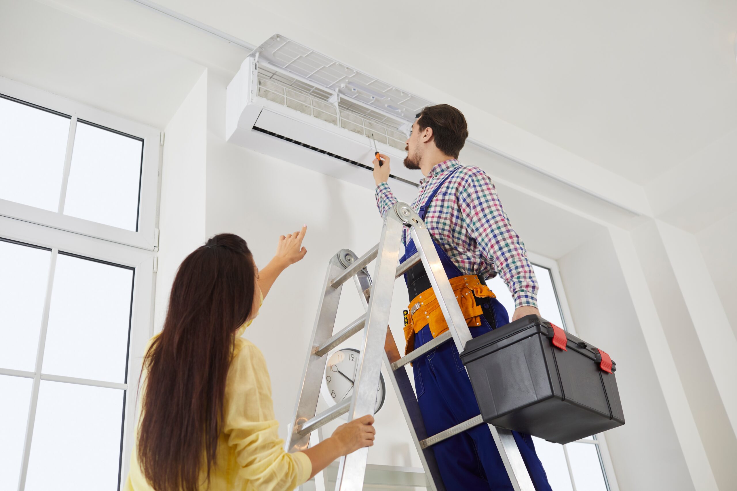 technician performing ac maintenance services that keep your cooling system running like new