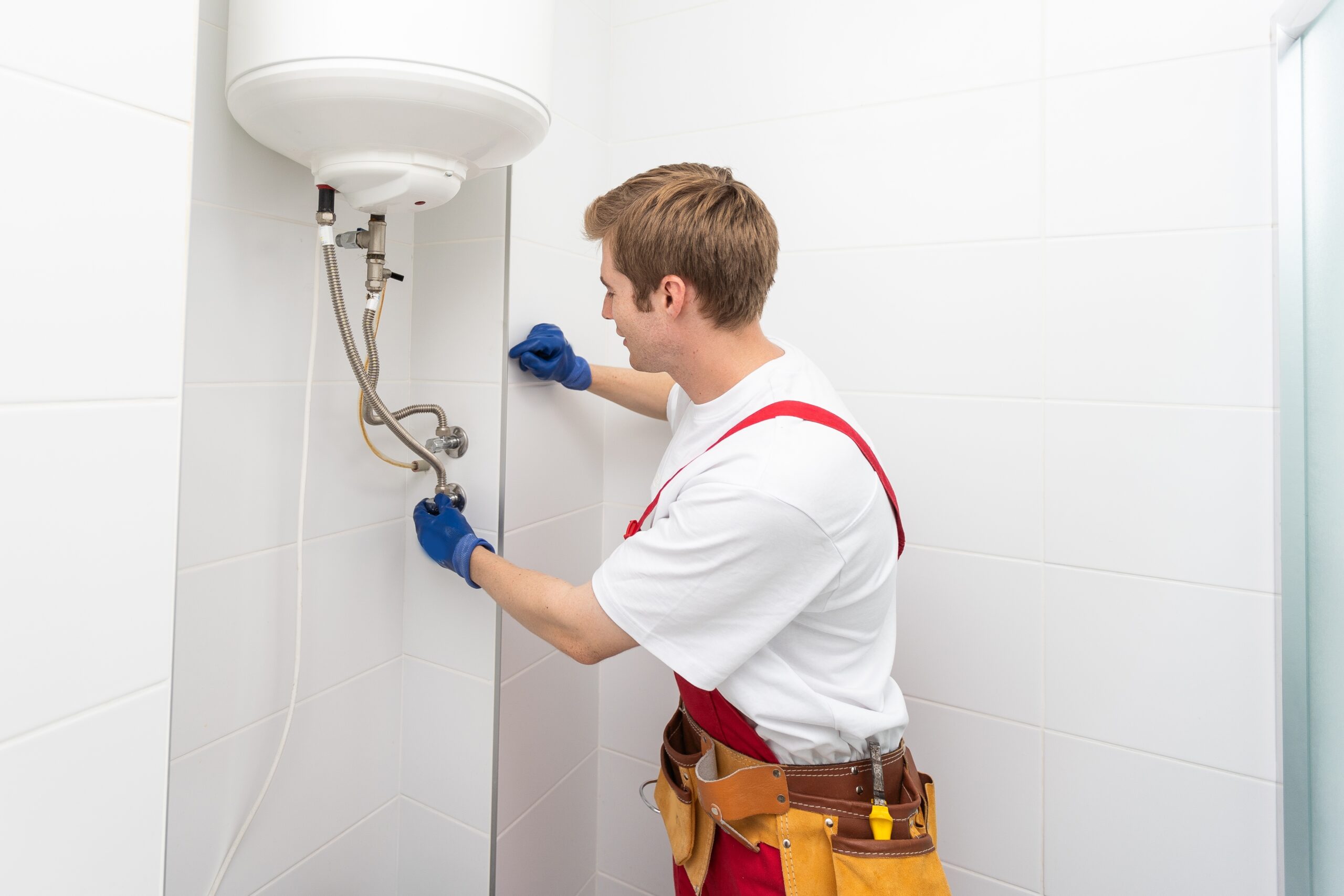 technician performing tankless gas water heater repair that solves ignition and flow issues safely