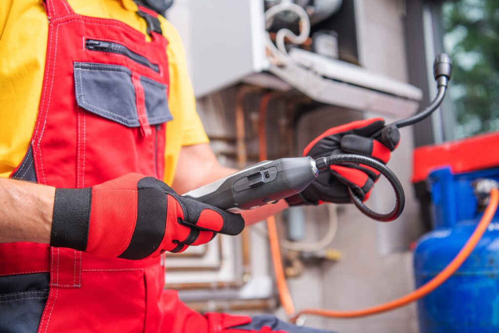 plumber using tools showing why homeowners invest in leak detection before disaster strikes