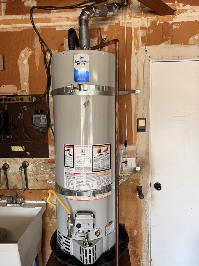 Conventional gas water heater with venting and water connections